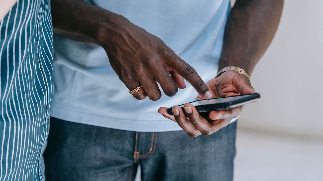 Close-up of a person swiping through content on a smartphone.
