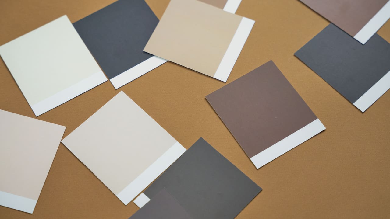 Colour swatches spread on a brown surface, seen from above.