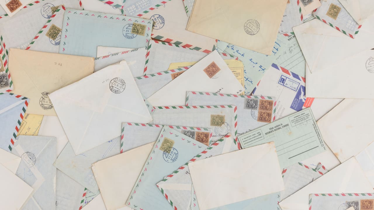 Vintage airmail envelopes and postcards with stamps.