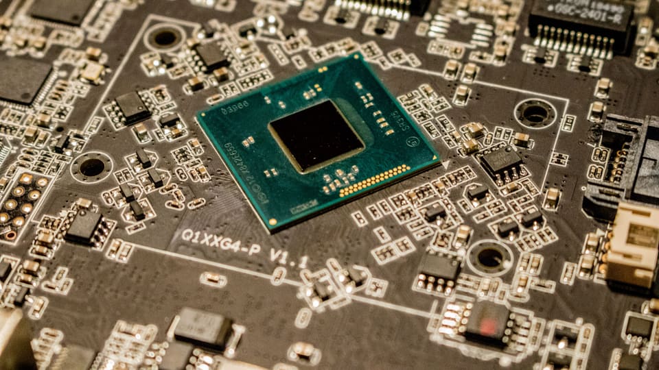 Detailed view of a microchip on a printed circuit board, showcasing electronic components.