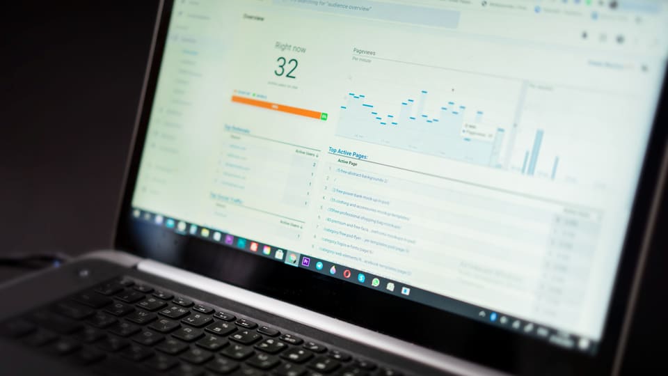 A laptop displaying an analytics dashboard with real-time data tracking and analysis tools.