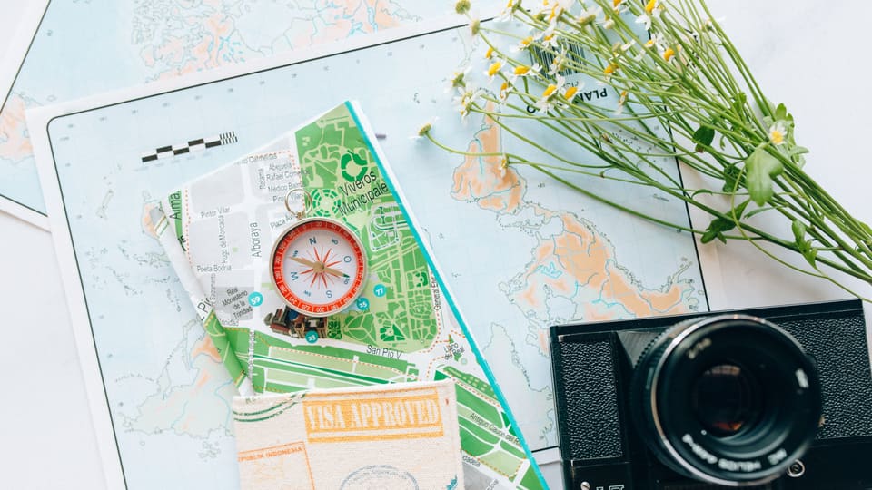 Explore your wanderlust with maps, a compass, and a vintage camera.