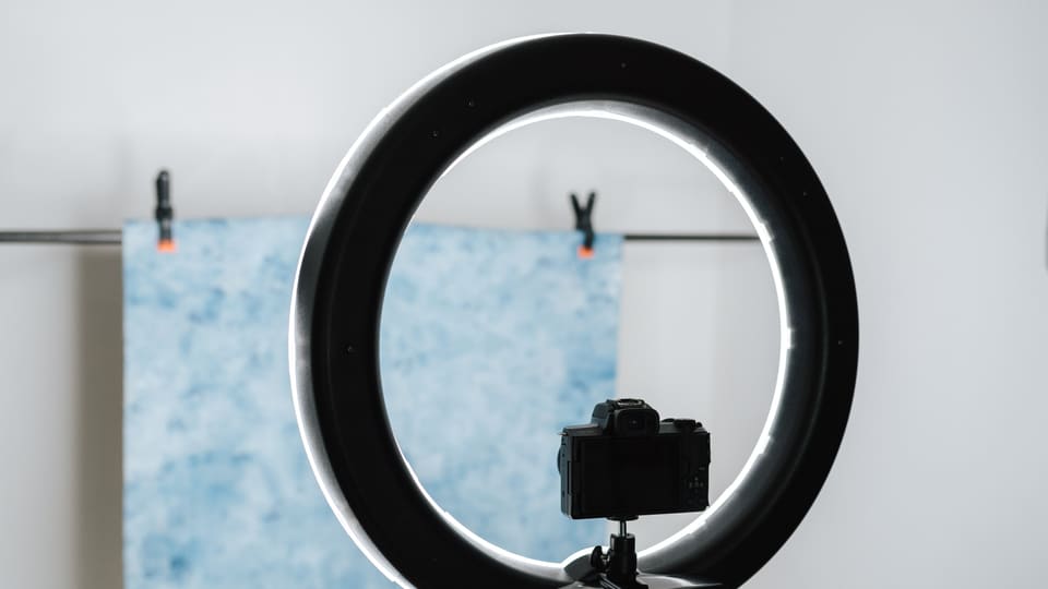 Contemporary photo camera and studio lamp prepared for photo session in professional studio